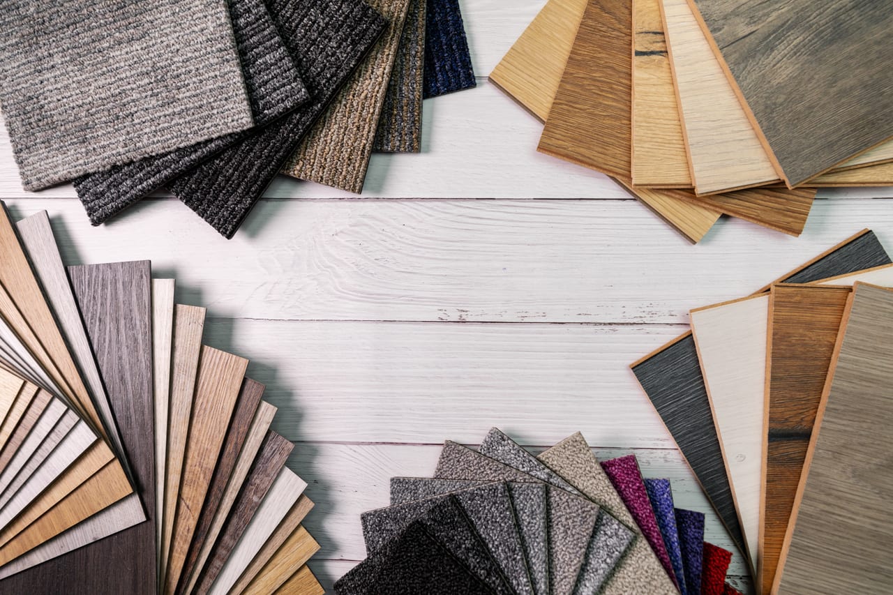 Fans of carpet, laminate and vinyl samples laid out on a table
